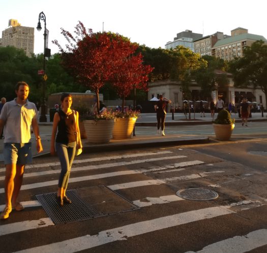 Photo of pedestrians in sunlight.